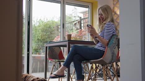 a woman sitting indoors using her phone