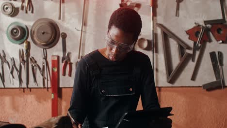 man working on tablet in workshop