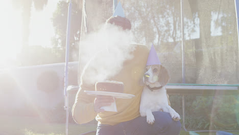 young man celebrating pet dog birthday in garden 4k 4k