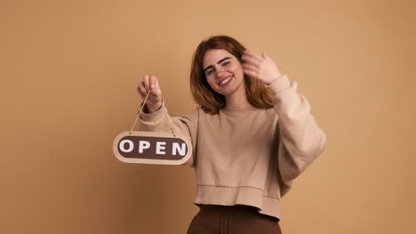 happy young woman inviting with open sign