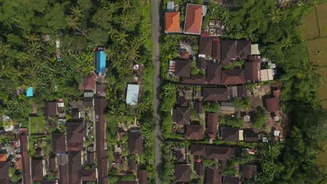 Overhead-top-down-aerial-birds-eye-view-of-rooftops-of-the-houses-in-a-typical-dense-residential-neighborhood-in-Bali,-Indonesia