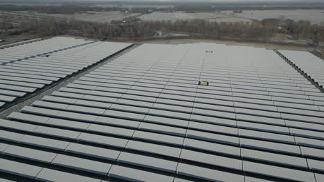 solar panels of solar power plant covered in snow and ice, frosty landscape, drone shot, slow movement forward