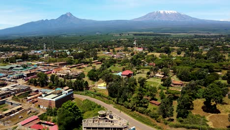 aerial drone view open air market in the loitokitok town, kenya and mount kilimanjaro- rural village of kenya