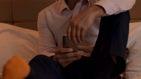 Businessman-using-mobile-phone-in-bedroom-4k