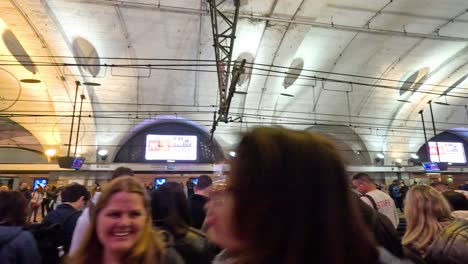 people waiting at a busy metro station