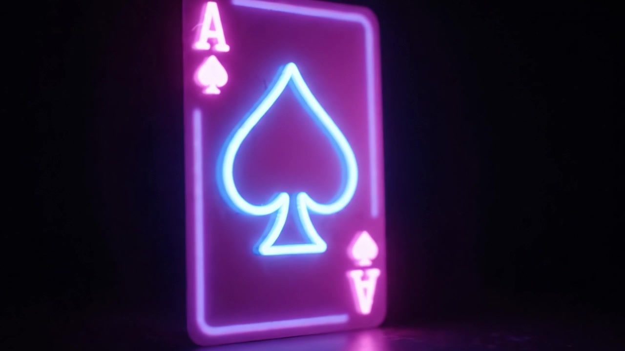 A vibrant neon representation of the Ace of Spades playing card, showcasing its iconic design. The glowing colors illuminate the card's details and create an eye-catching visual appeal.