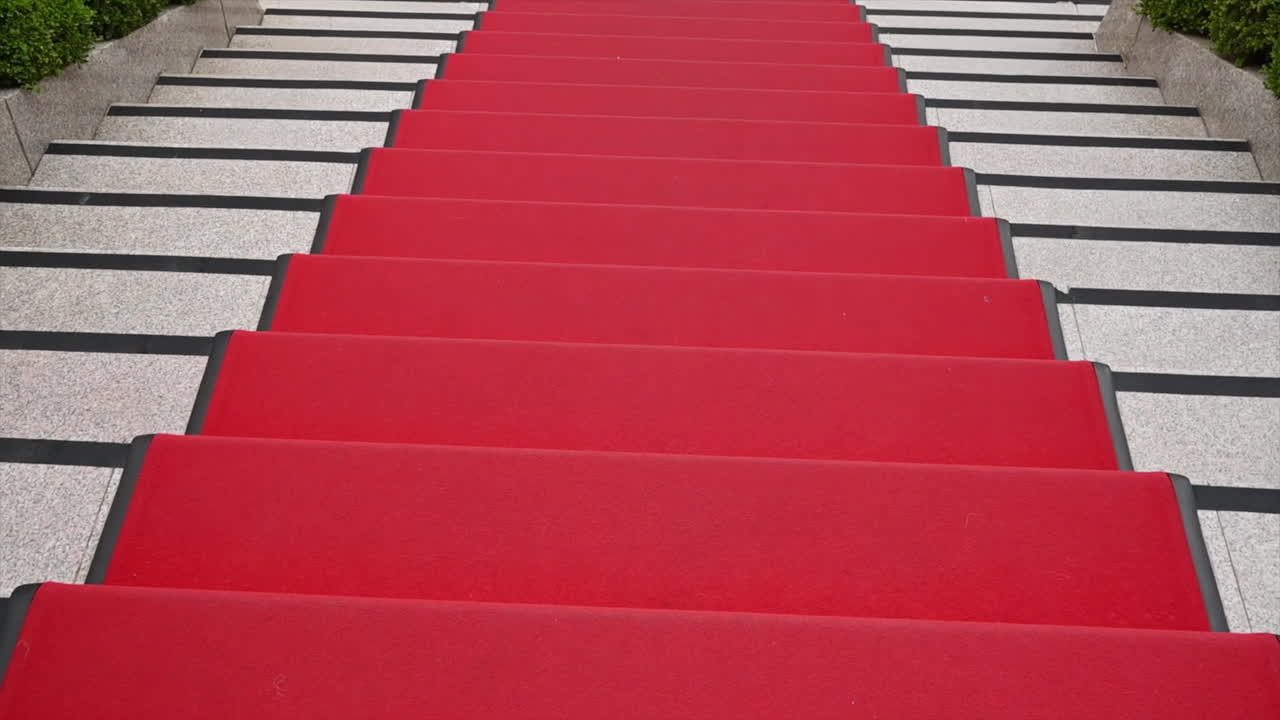 Walking on red carpet stairs
