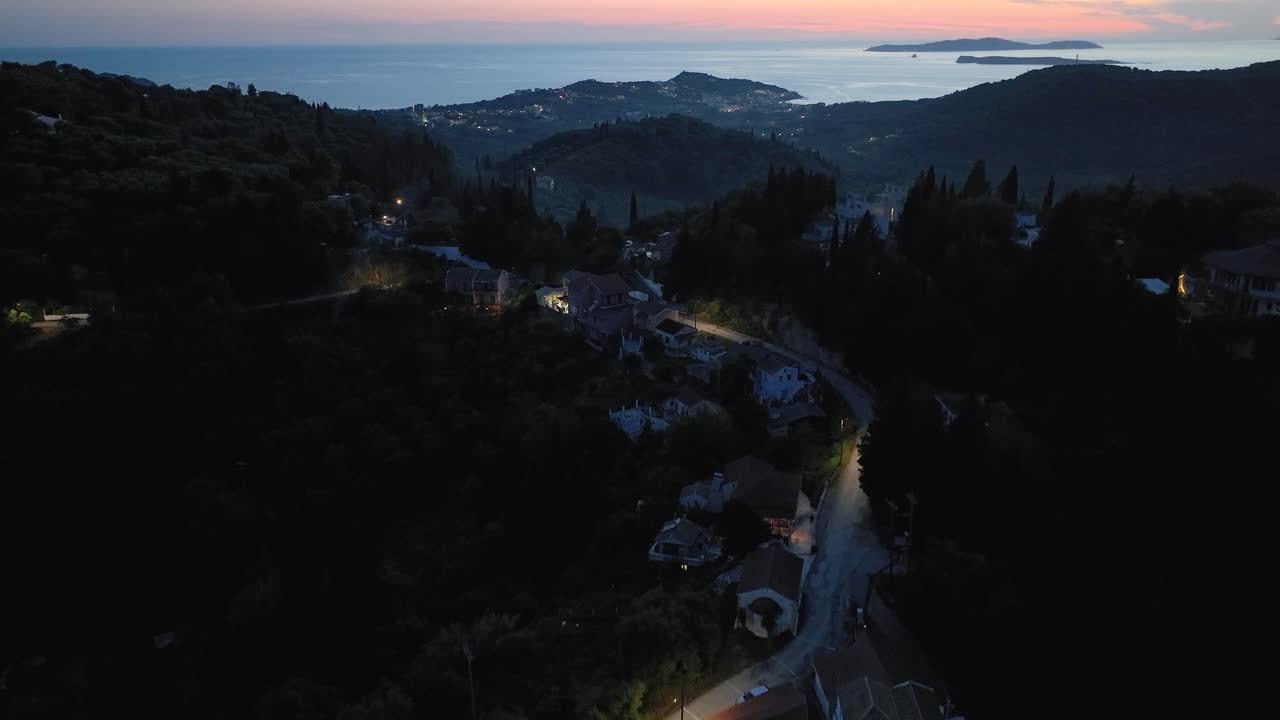 Corfu Hills at Dusk: Illuminated Landscape and Ionian Sea View