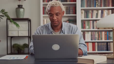 close up of young african american businessman opening laptop and start working