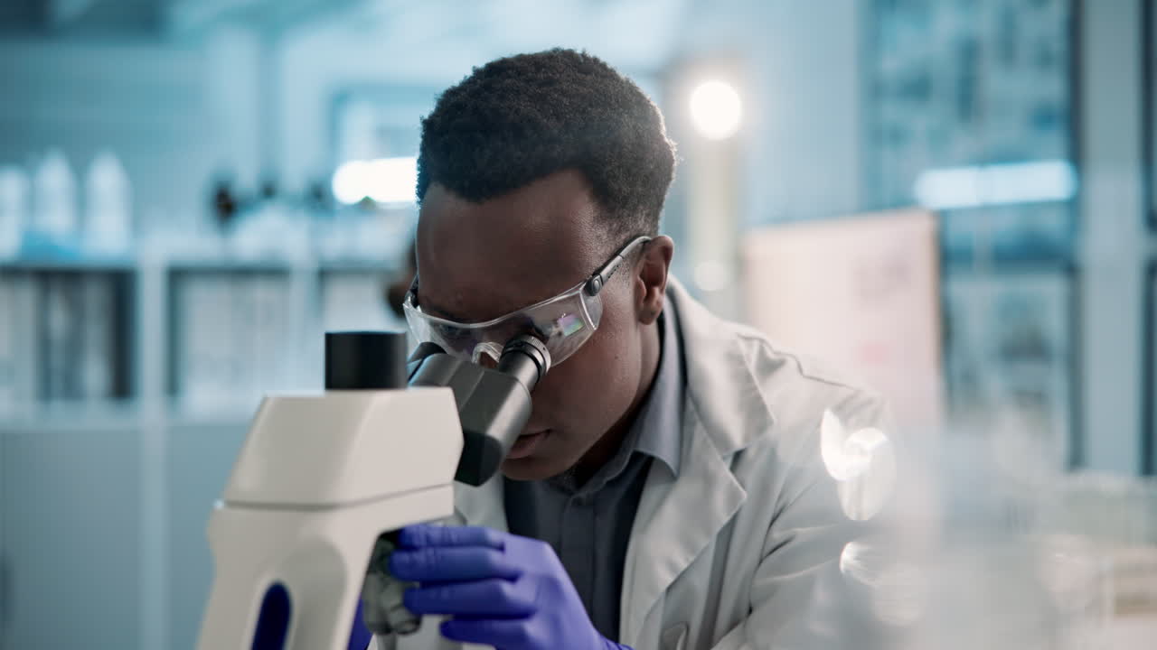 Scientist using microscope in laboratory