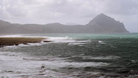 stormy coastline with mountain view