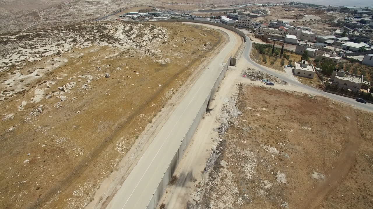 Aerial View of a Separation Barrier and Road Dividing Arid and Developed Land