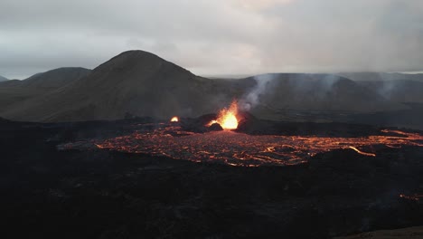 Experience-the-awe-of-Fagradalsfjall's-summer-eruption-in-2022-through-an-epic-4K-drone-perspective,-showcasing-the-volcano's-raw-power-and-mesmerizing-flow