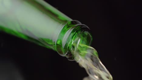 crystal clear water flowing from green bottle