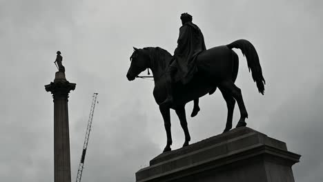 nelson's column and the equestrian statue of king george iv within trafalgar square, london, united kingdom