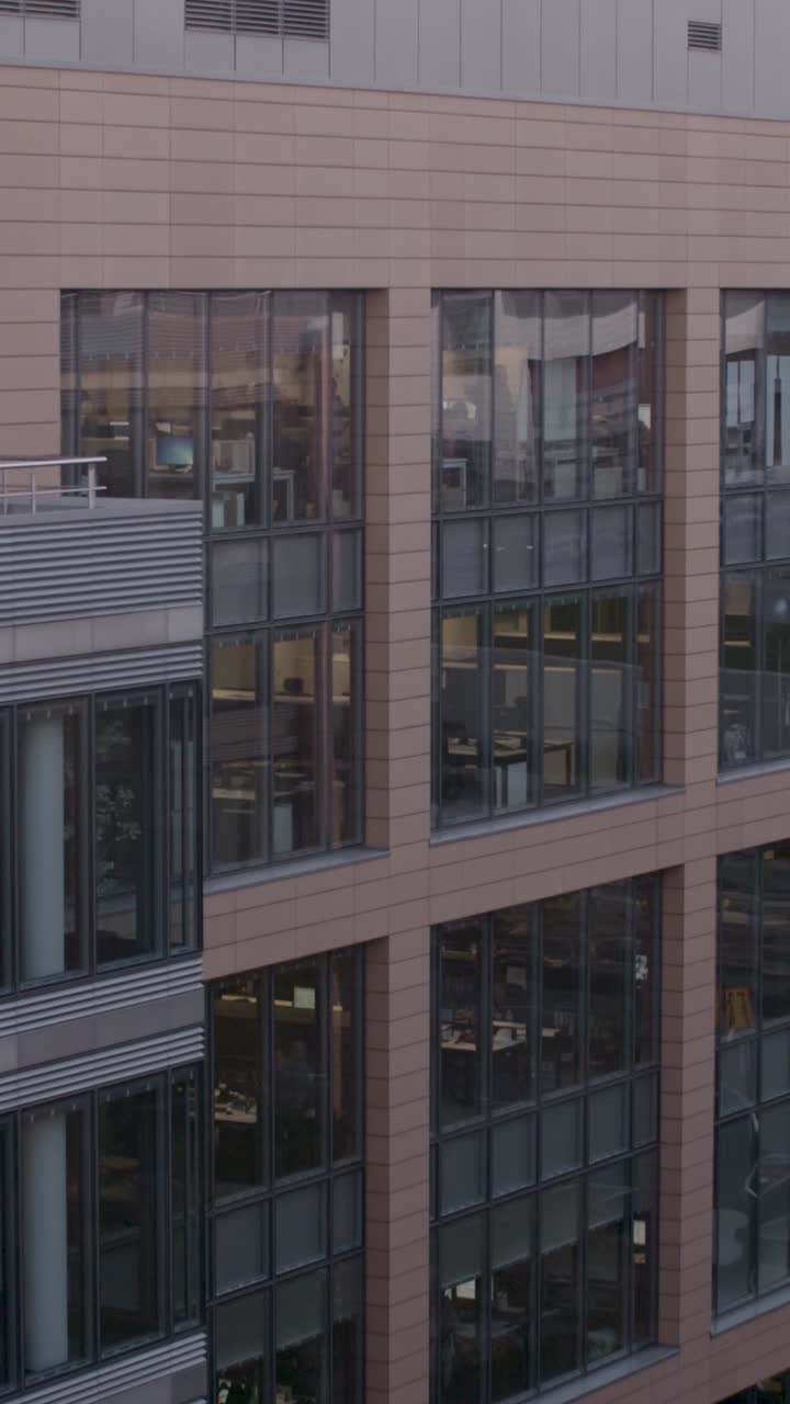 Modern office building with large windows in urban setting, exterior view