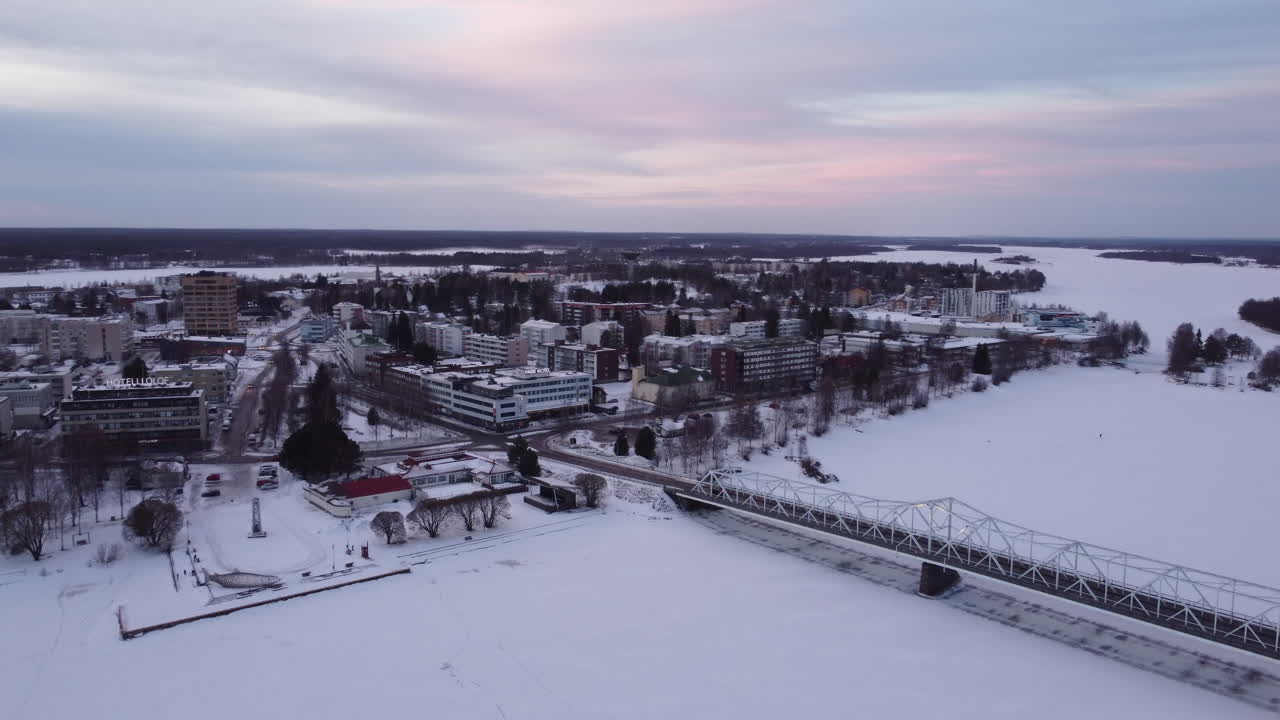 Bridge Over Frozen Torne River At Tornio City In Finland During Winter. Aerial Drone Shot