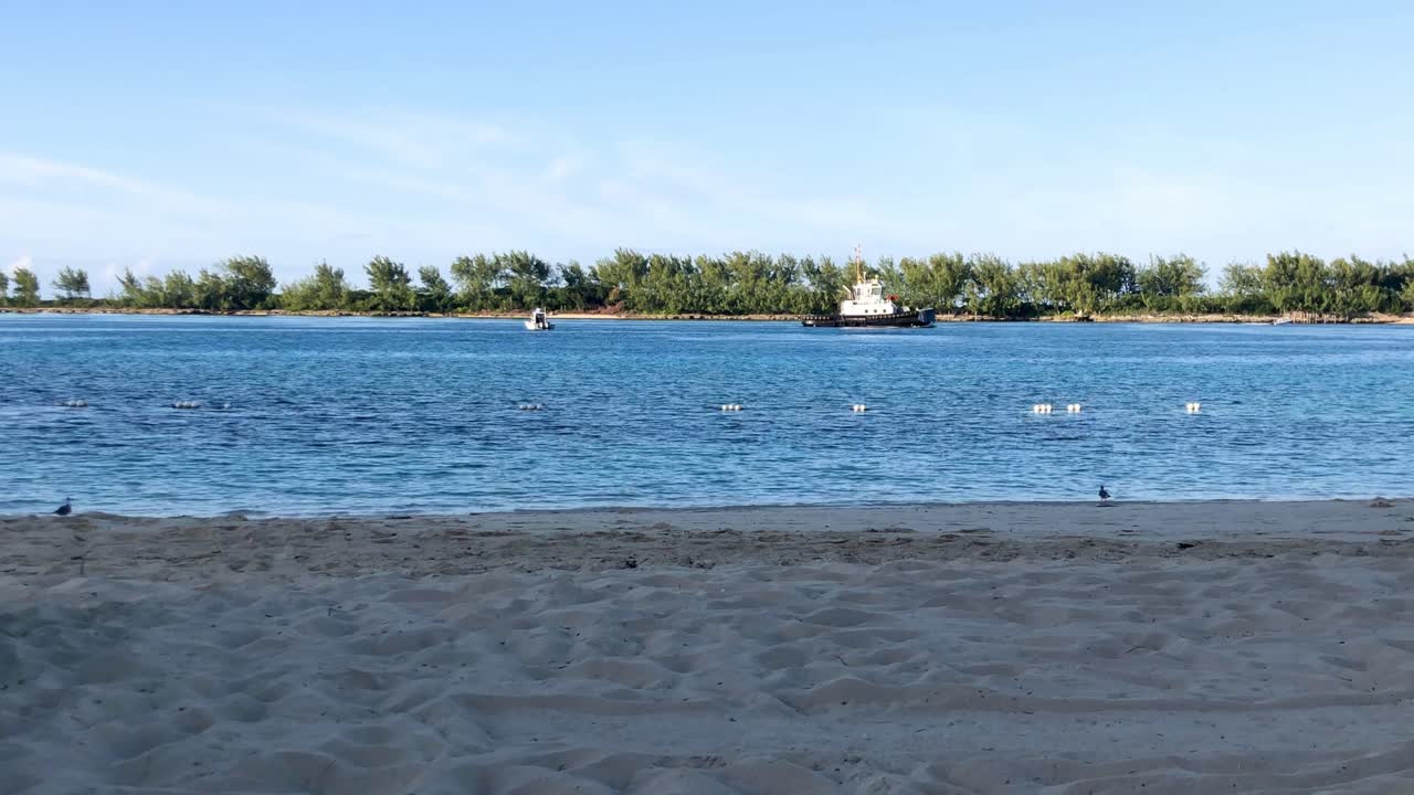 나소 4k 30fps의 바하마 열대 섬 근처 수정처럼 맑은 물에서 항해하는 예인선