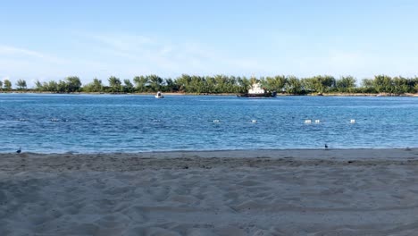 Tugboat-sailing-in-crystal-clear-water-near-tropical-island-of-Bahamas,-Nassau-4K-30-FPS