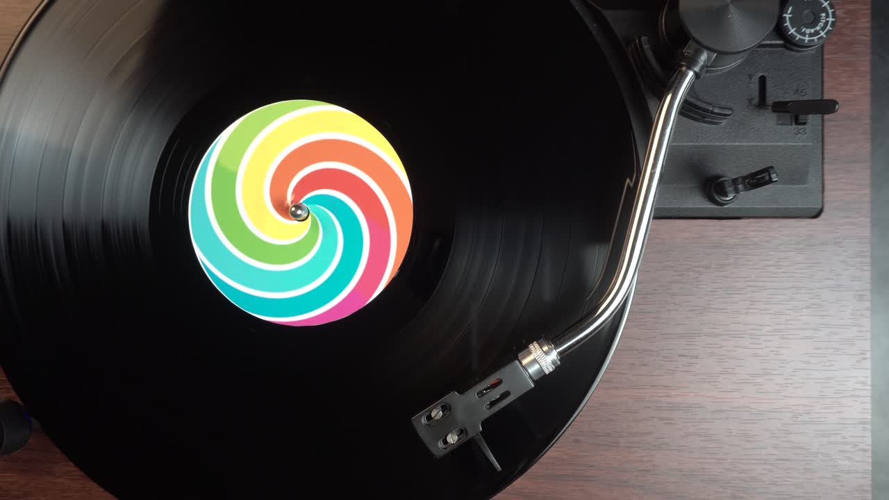 Placing Needle on Vinyl Audio Record on Spinning Vintage Turntable, Top Down View