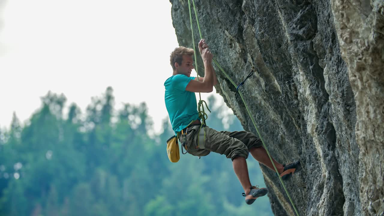 Close-up shot of a rock climber hanging from a rope.Vertical rock. Extreme sport