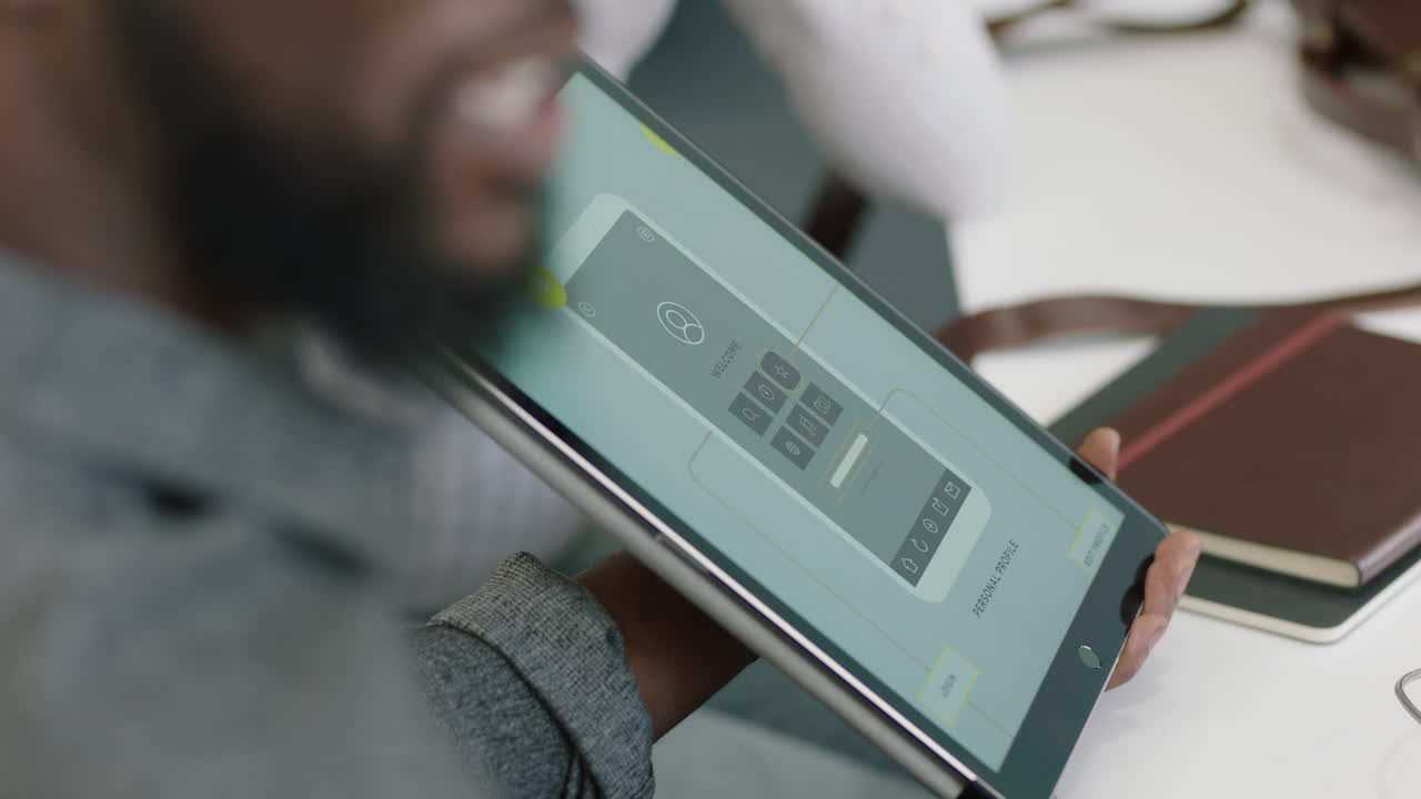 젊은 아프리카계 미국인 엔지니어들이 디지털 태블릿 컴퓨터를 사용하여 모바일 소프트웨어 애플리케이션을 개발하고 디자인 솔루션을 브레인스토밍하고 아이디어를 공유하고 스타트업 사무실에서 협력합니다.