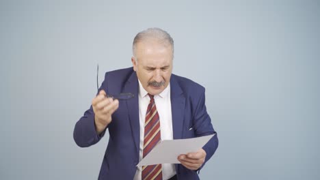 businessman examines paperwork and gets upset.