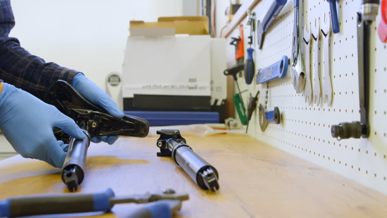 Man repairing bicycle seat in workshop 4k
