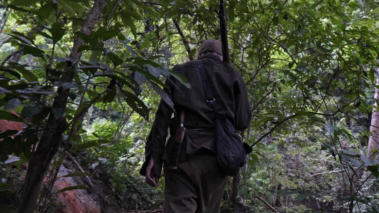 Senior Hunter Walking In Deep Forest