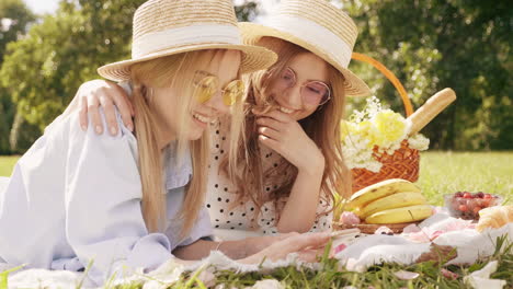 two friends enjoying a picnic in the park