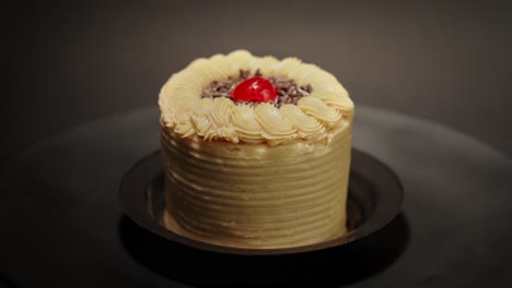 mini-individual-portion-personal-petite-slice-Mocca-cake-in-a-turn-table-loop-with-black-background