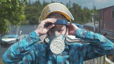 a young male carpenter wearing appropriate safety equipment