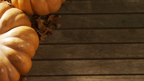 Calabaza-De-Halloween-Con-Hoja-De-Arce-Sobre-Una-Mesa-De-Madera-4k