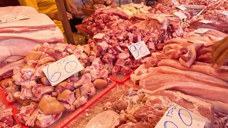 butcher arranging various meats on display