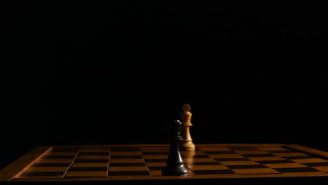 two king chess pieces are facing each other on opposite side's of the chessboard