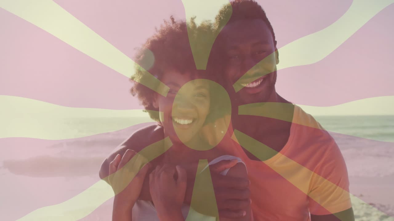 man hugging woman on sandy beach, displaying animated sunburst graphic, promoting wellness concept