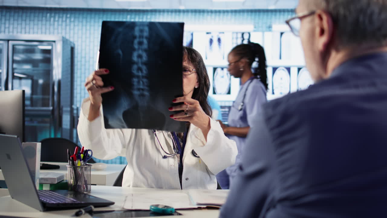 Vertical Video Female general practitioner giving bad worrying news to elderly man