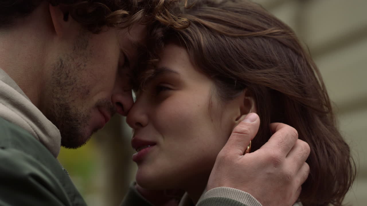 야외에서 데이트를 즐기는 사랑의 커플. 도시 거리에서 여자 얼굴을 만지는 남자.