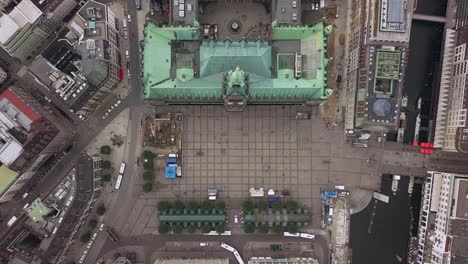 flying above the town hall of hamburg city germany, gaining hight, looking strate down