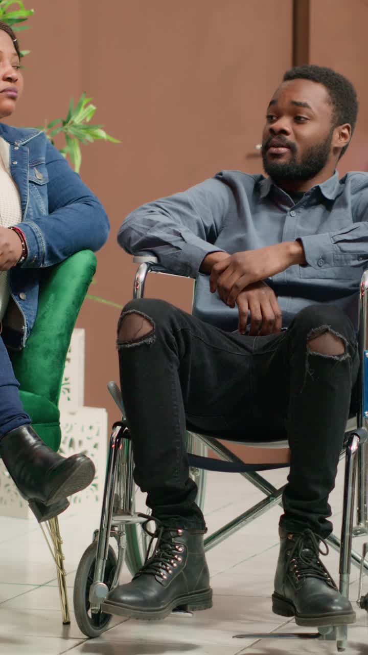 Vertical video Wheelchair user hotel guest in lobby
