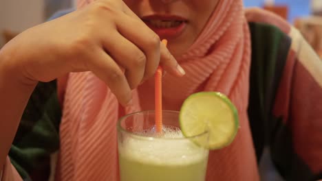 woman drinking a refreshing lime juice