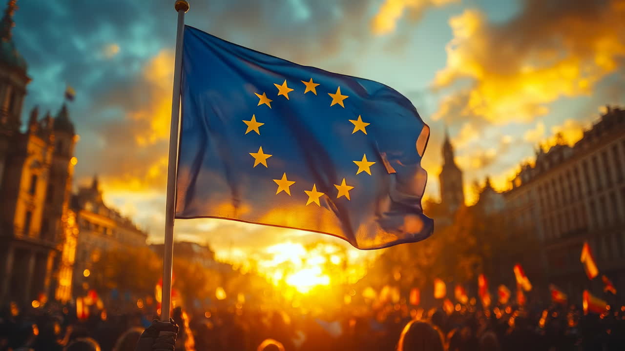 Crowd gathers at sunset to support European unity and values while holding flags