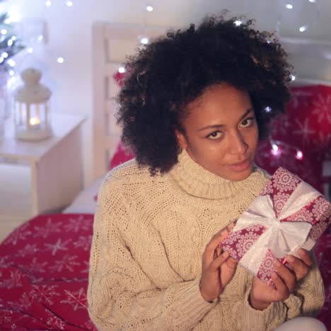 Smiling--woman-holding-Christmas-gift