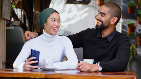 Young-couple-having-fun-in-cafeteria-4k