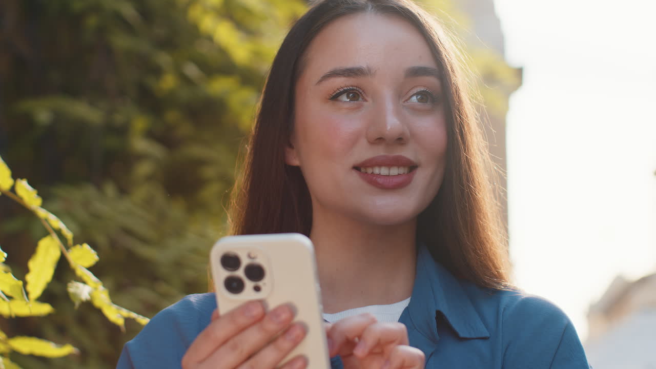 Young woman using smartphone typing text messages looking for a way on map in mobile navigator app