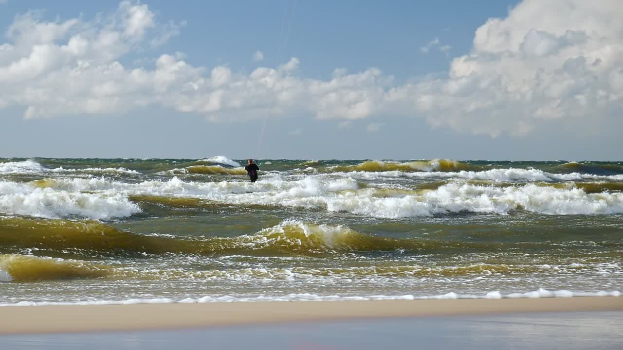 Man On a Kitesurfing Board on High Waves of Baltic Sea, Poland.