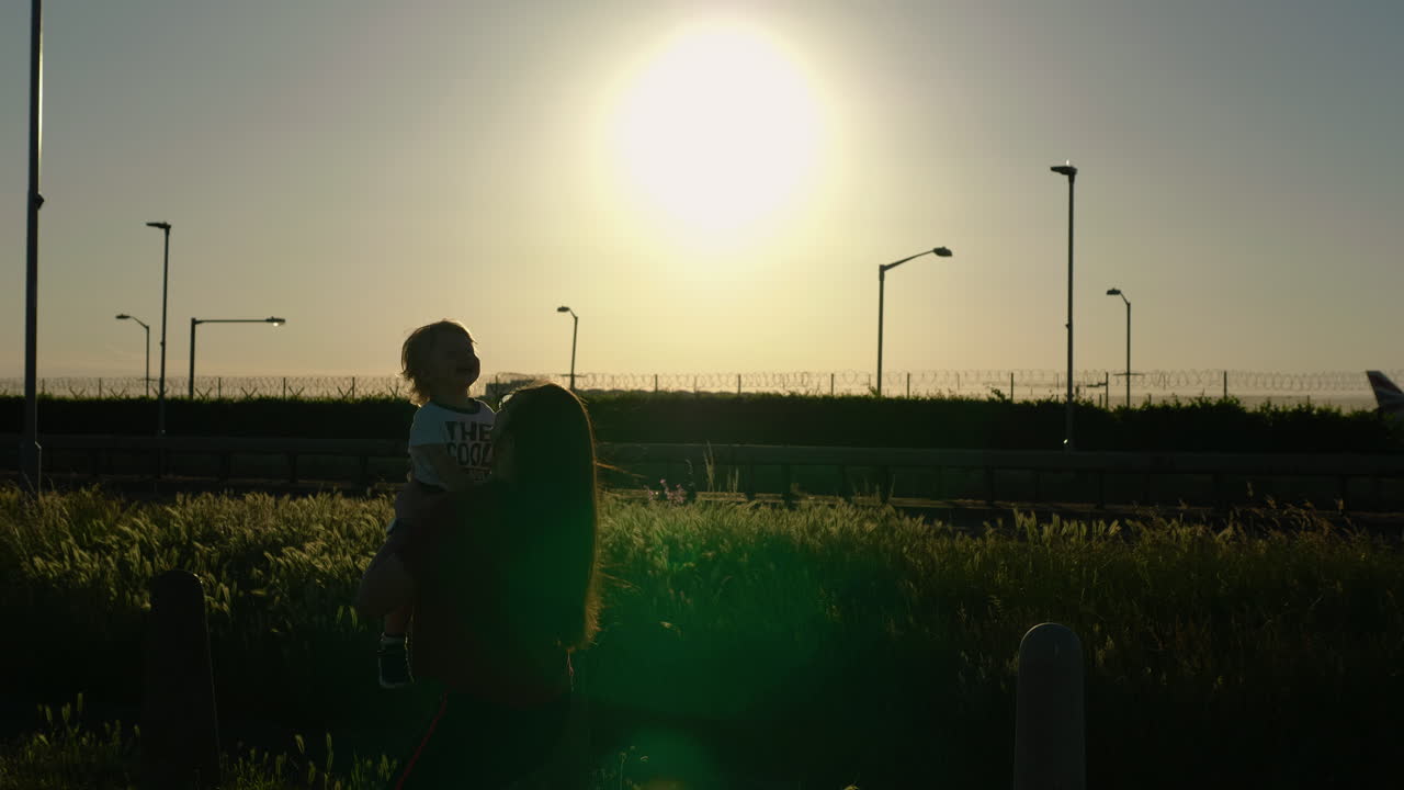 Silhouettes of mom and son playing and having loads of fun, laughter and giggle