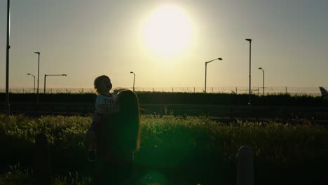 silhouettes of mom and son playing and having loads of fun, laughter and giggle