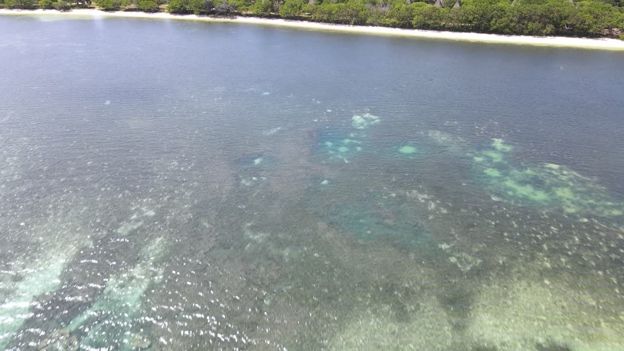 Drone aerial moving forward and panning up to show huts in New Caledonia Sheraton