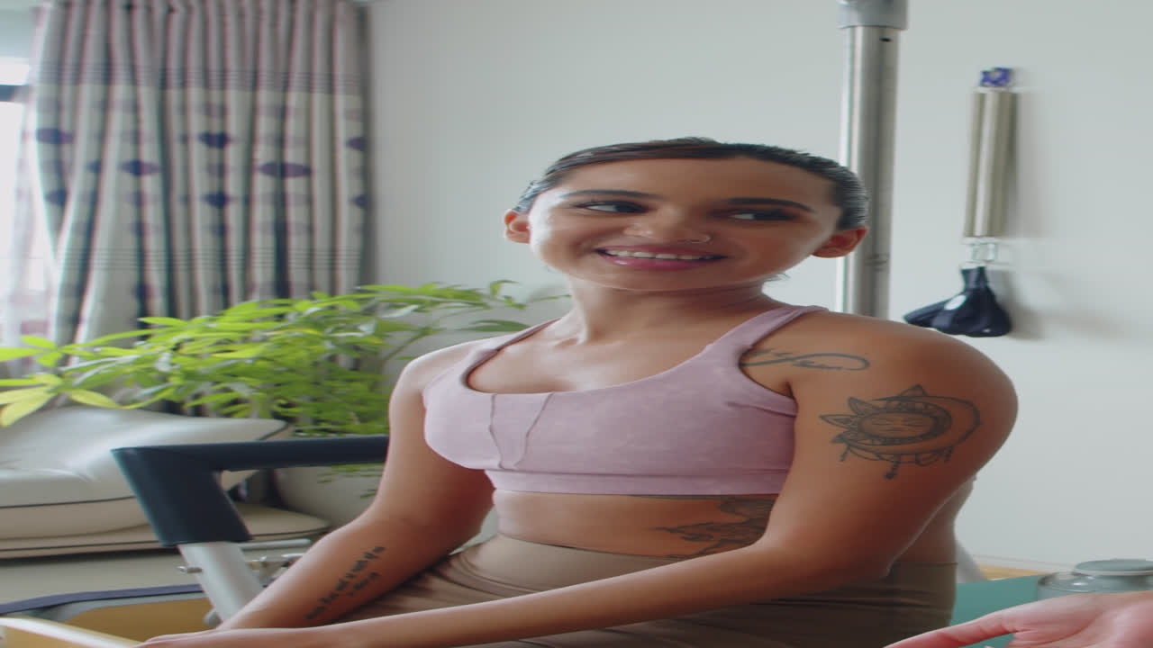 Asian Woman Talking to Trainer after Workout